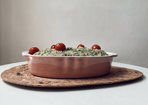 The final layer of the tiella is placed with the mussels and placed in a ceramic baking tray, ready for the oven