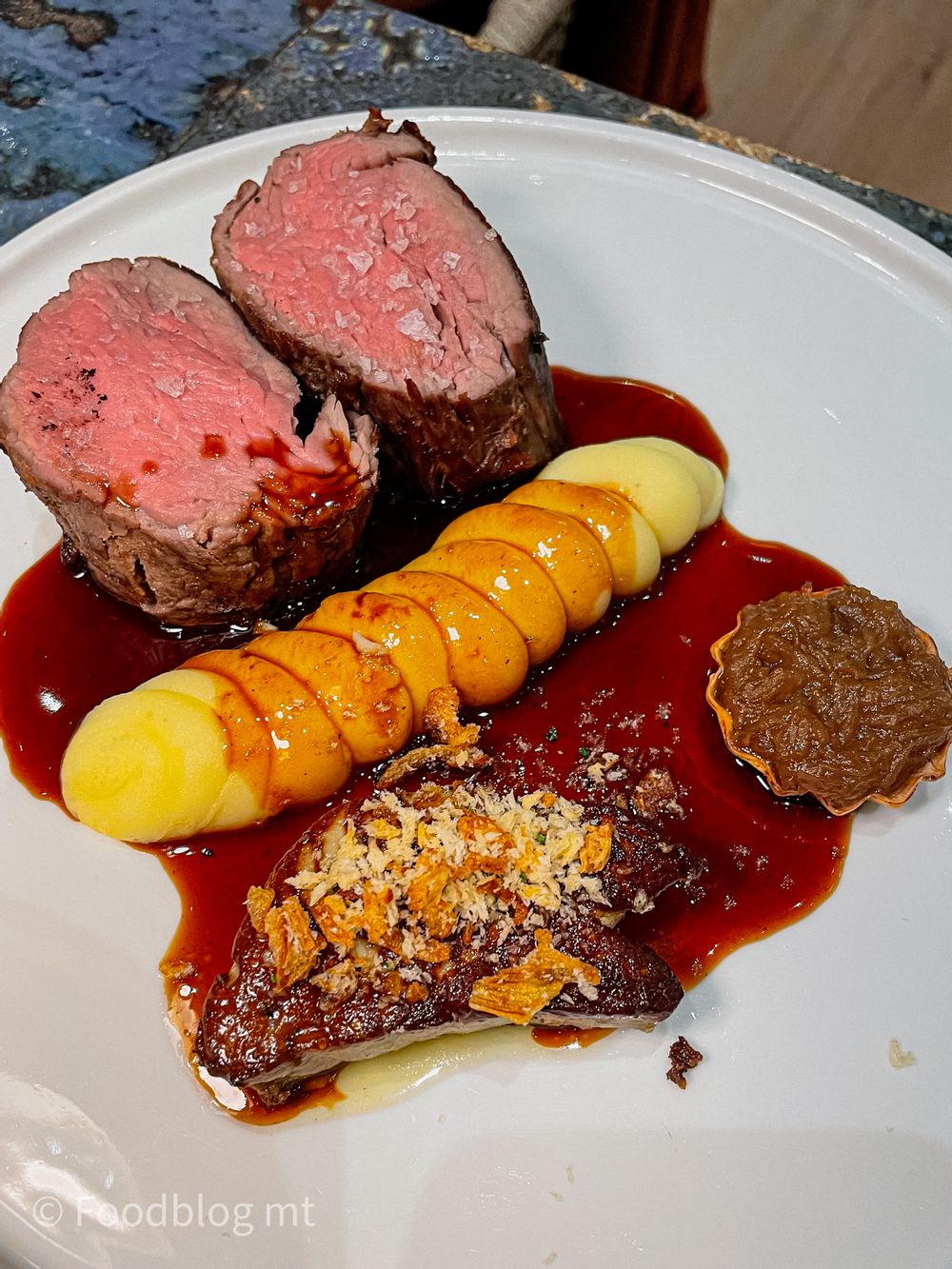 Slow cooked fillet of beef with foie gras, caramelised onion tart and jus