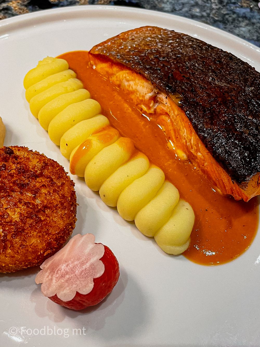 Pan seared Scottish salmon, brandade beignet, turnip, tomato emulsion and beurre blanc