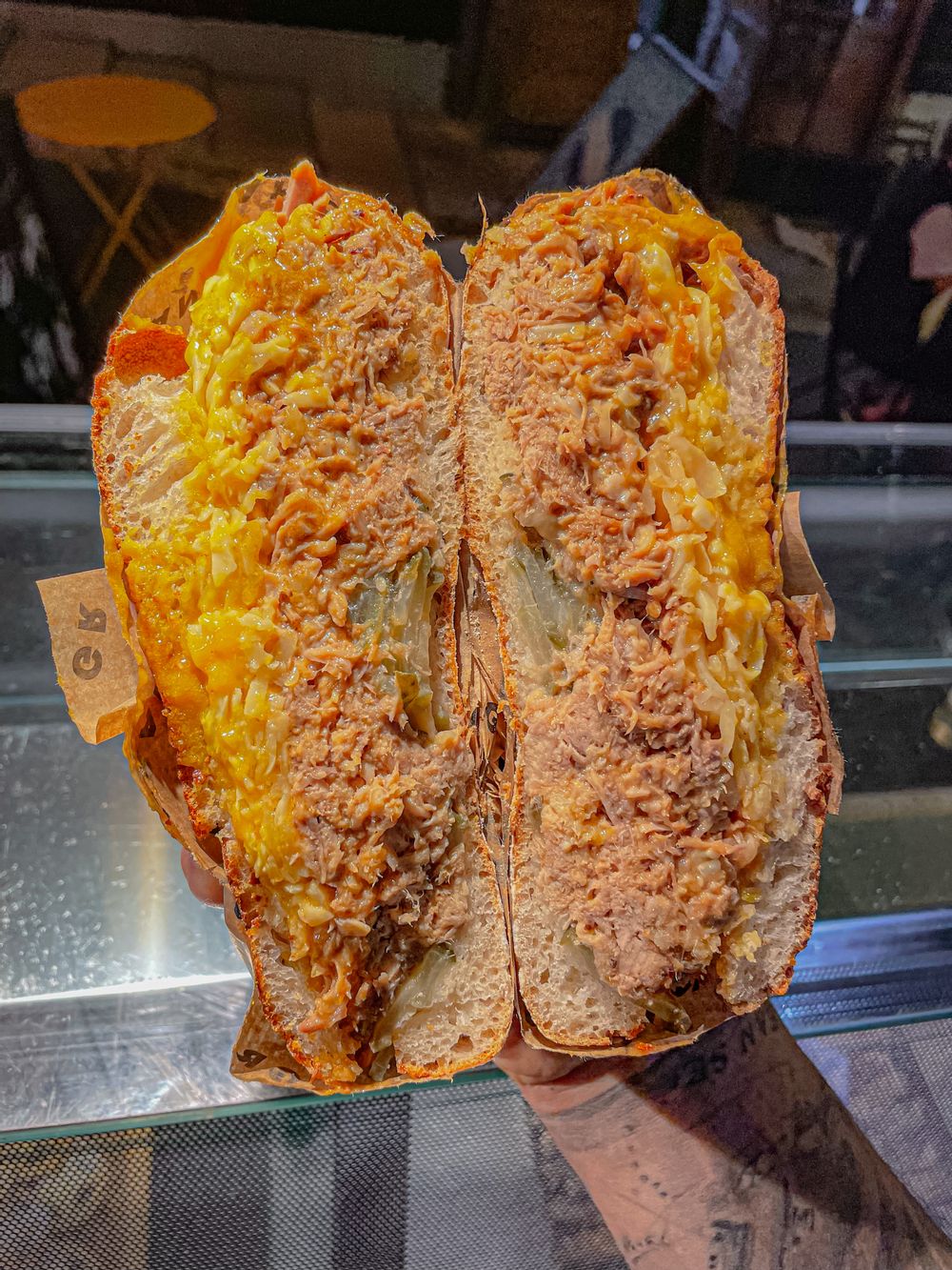 The Hogwich: slow-roasted local pork shoulder, applewood cheese, house golden BBQ sauce and pickles,