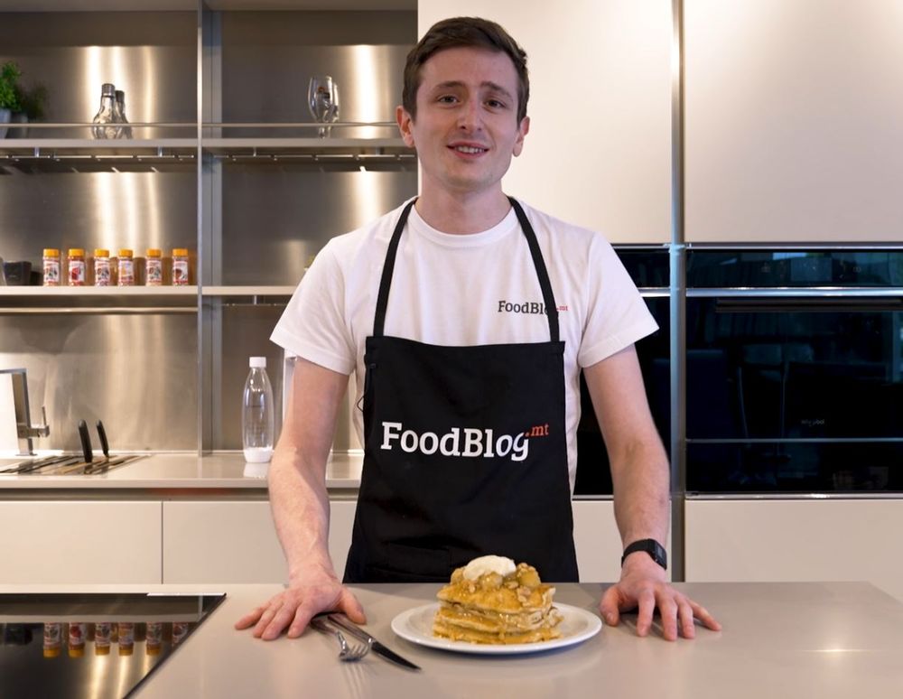chef stephen la rosa taking a bite out of the pancake stack he just made at fino kitchen with lamb brand products