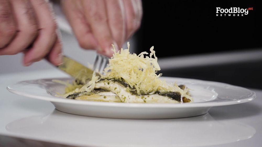 Marvin Gauci digging into the final plating of the sea bass with crispy potatoes from FoodBlog Marvin's Five