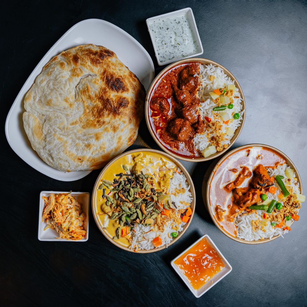 Curry, rice, naan and condiments at Indian restaurant The Tiffin Box Malta in Sliema.