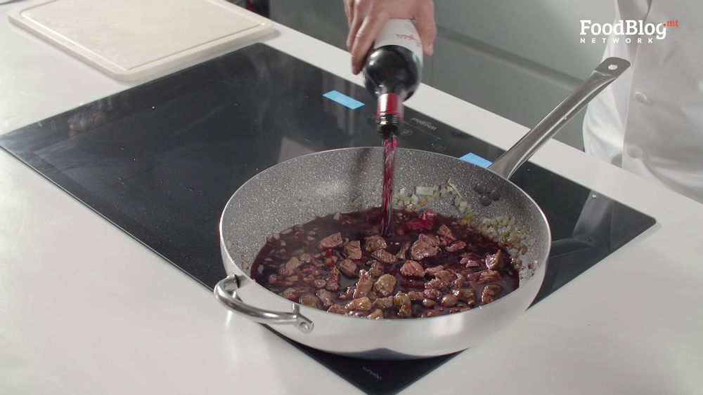 Marvin Gauci adding red wine to the meat onion and sweet chilli mixture on FoodBlog's Marvin's Five
