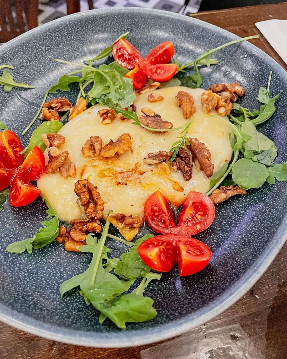 Slightly melted pecorino cheese with a drizzle of honey and walnuts from Sotto Pinseria in St. Julian's, Malta.