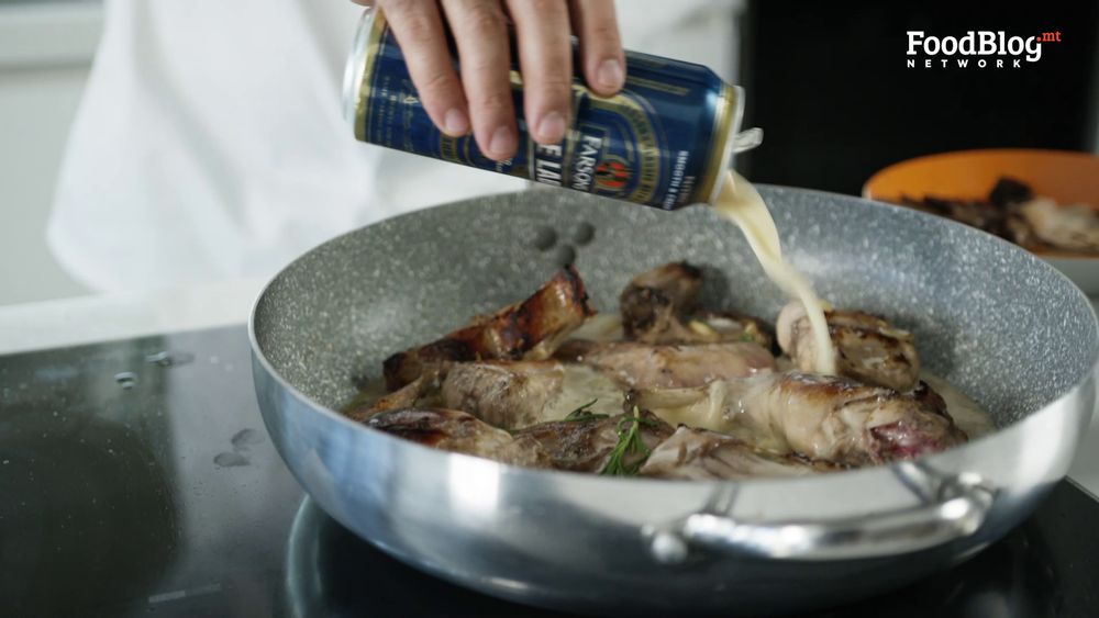 pouring amber ale, blue label on the rabbit which is being seared