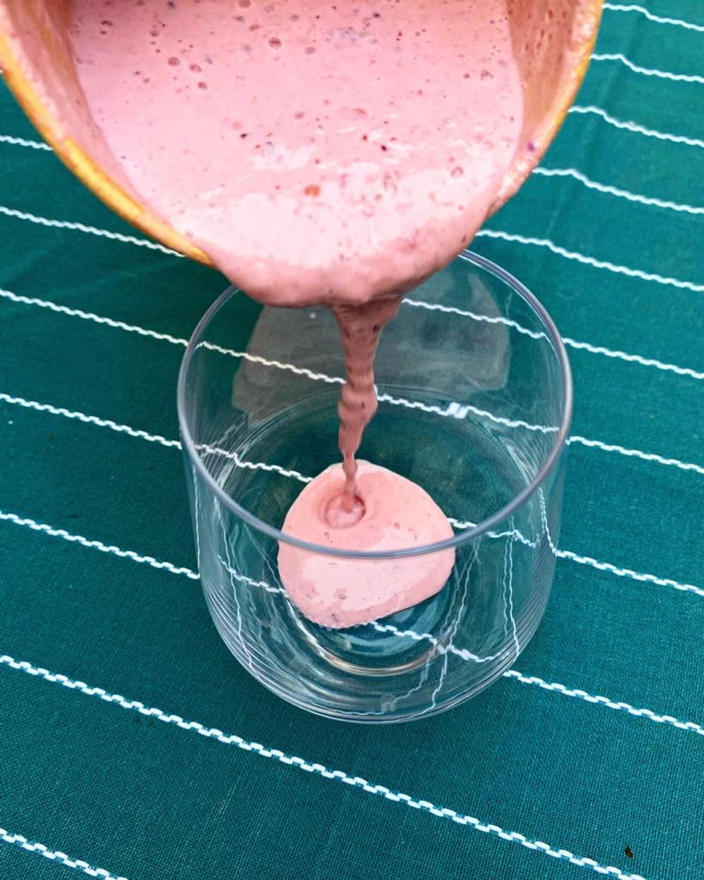 Berry Shake being poured from container to glass