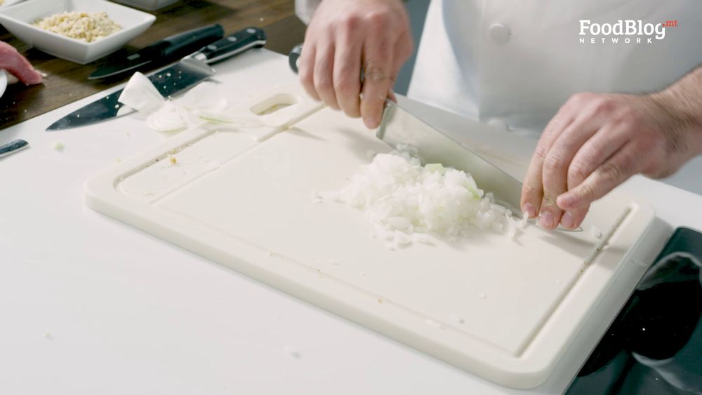 Marvin Gauci dicing onions for them to be fine on FoodBlog's Marvin's Five