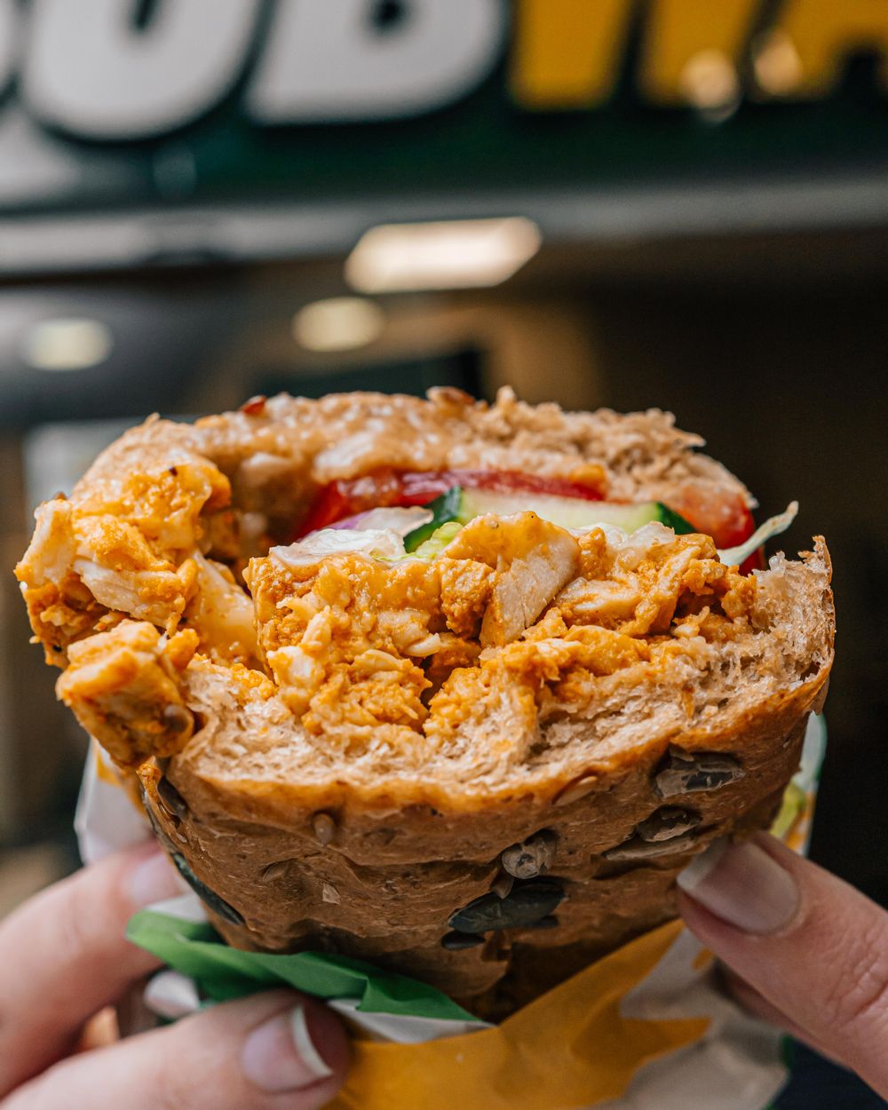 Chicken Subway with cucumber, tomatoes and lettuce on a multi seed bun.