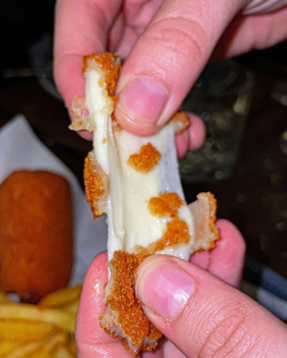Cheese pull from the Mozzarelline at Sotto Pinseria in St. Julian's, Malta.
