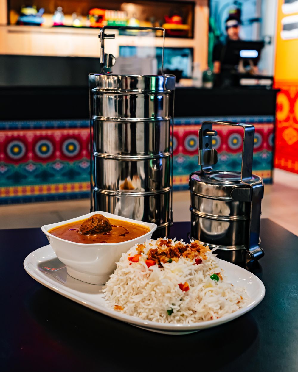 The Tiffin Box at the plaza in sliema malta serving curries in a tiffin box for takeaway.