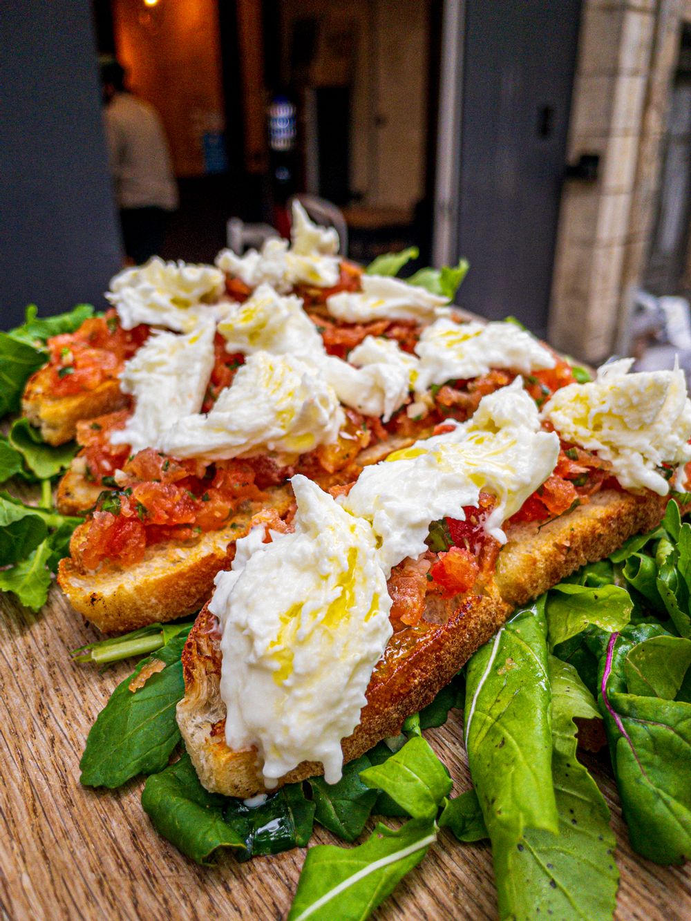 4 pieces of bruschetta with fresh tomatoes and bufola mozzarella from Stanjata Cafe. 